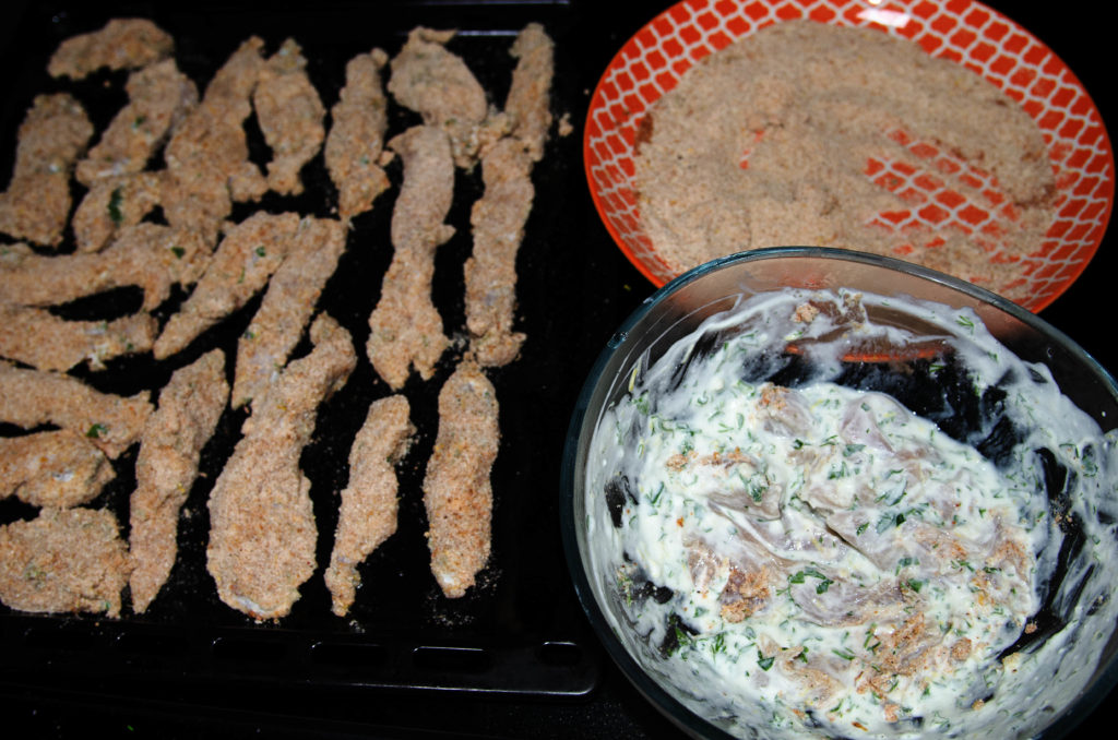 Prepared ingredients for chicken in yogurt sous vide: yogurt marinade, sliced fillet, breading mix