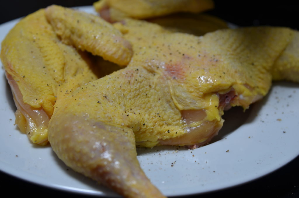 cut up tobacco chicken with a sprinkle of pepper.