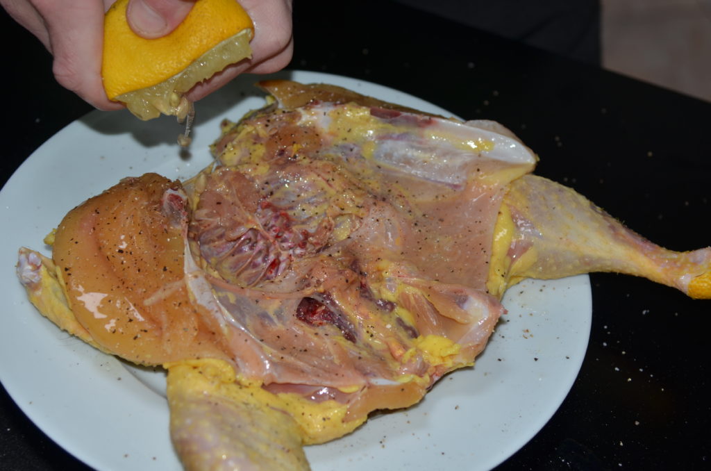 cut tobacco chicken sprinkled with pepper and drizzled with lemon juice.