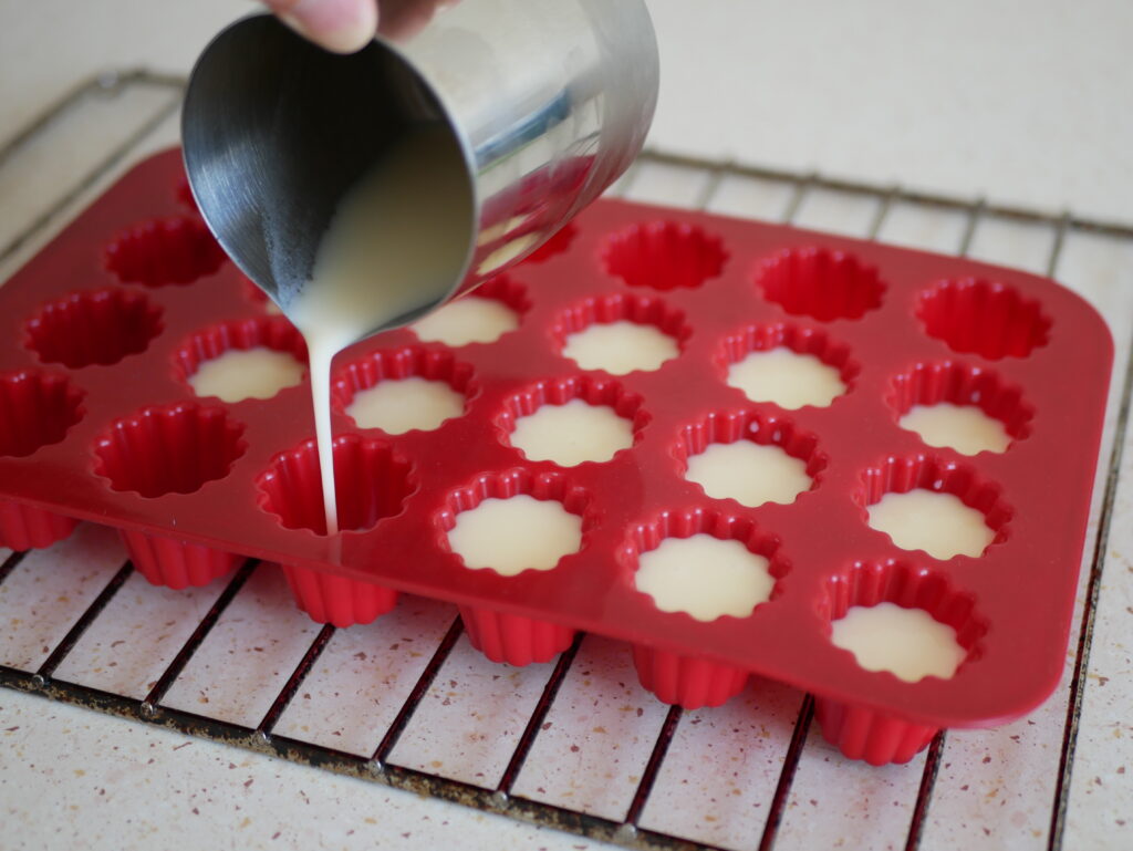 Pouring the dough into the cannelle molds