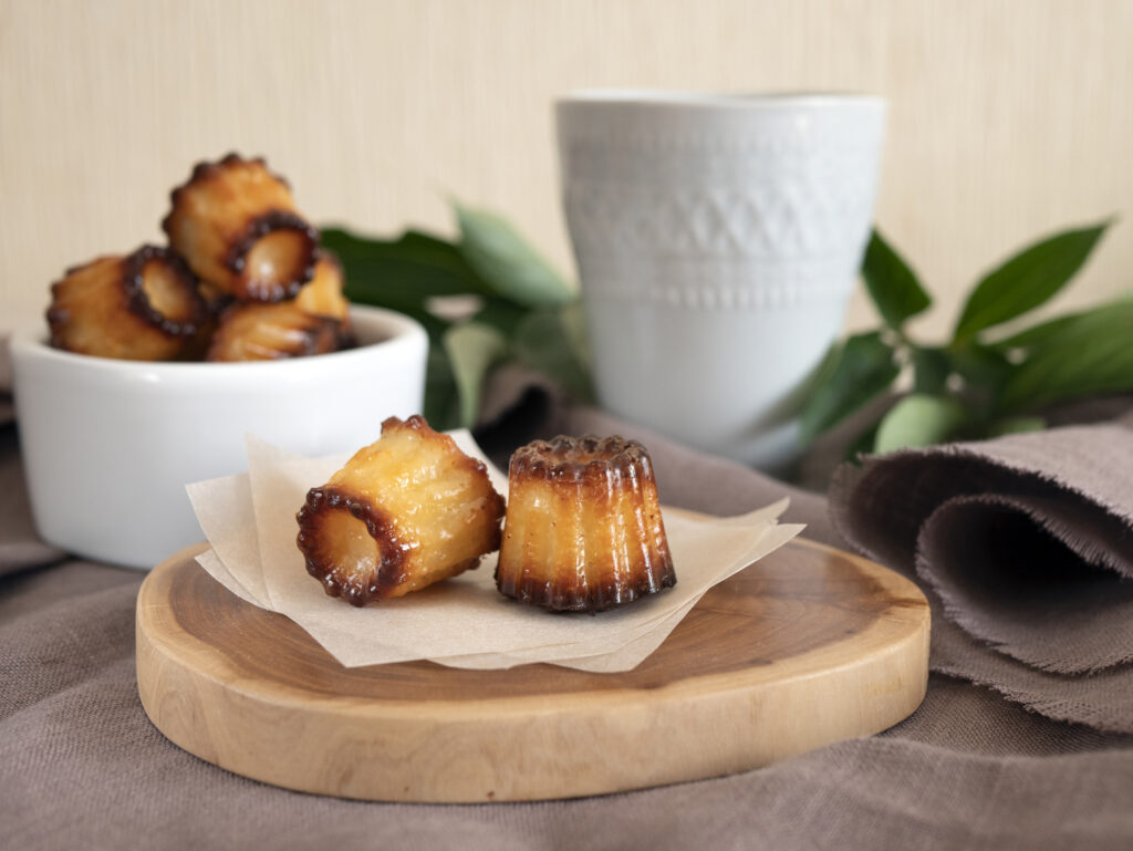 flavorful cannelles with a cup of hot tea